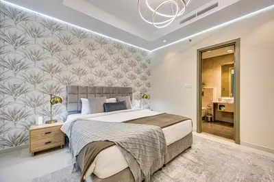 a bedroom with a large bed and a wall mural at Elegant apartment in Paramount Midtown residence in Dubai