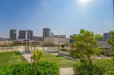 an aerial view of a building with a park at EasyGo - Sobha Waves 1 Bedroom & Study Modern in Dubai