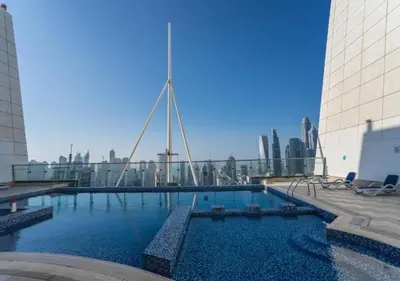 a large swimming pool in the middle of a building at Cosmos Living Spacious with Balcony GCV1 in Dubai