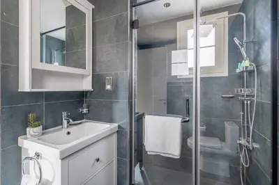 a bathroom with a sink and a glass shower at GuestReady - Springs Serenity near Golf Club in Dubai