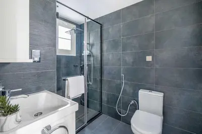 a bathroom with a shower and a toilet and a sink at GuestReady - Springs Serenity near Golf Club in Dubai