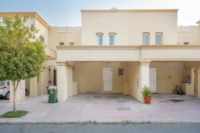 a large building with a parking lot in front of it at GuestReady - Springs Serenity near Golf Club in Dubai