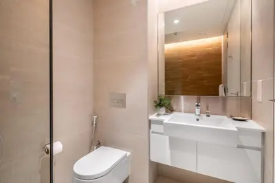a bathroom with a sink and a toilet and a mirror at GuestReady - Majestic Ain Dubai from your balcony in Dubai