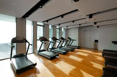 a row of treadmills in a gym with wood floors at GuestReady - Majestic Ain Dubai from your balcony in Dubai