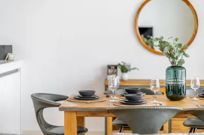 a dining room table with chairs and a mirror at GuestReady - Majestic Ain Dubai from your balcony in Dubai