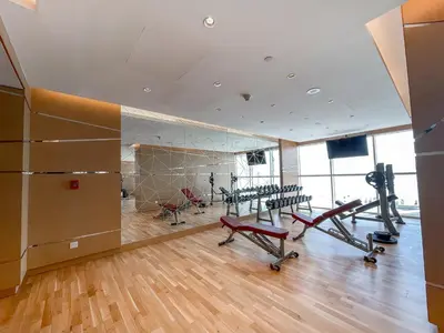 a gym with treadmills and exercise equipment in a building at Executive Studio in Damac Hills by Suiteable in Dubai