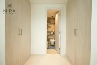 a hallway with a bathroom with a toilet in it at Mira Holiday Homes - Lovely 1 bedroom with beach access in Dubai