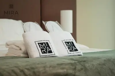 two towels with the letter m on top of a bed at Mira Holiday Homes - Lovely 1 bedroom with beach access in Dubai