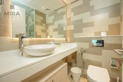 a bathroom with a sink and a toilet at Mira Holiday Homes - Lovely 1 bedroom with beach access in Dubai
