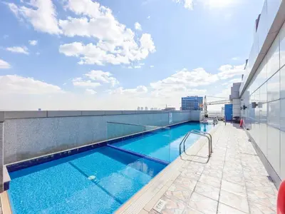 a swimming pool on the roof of a building at Special Rates - Elegant Studio - Golf Views in Dubai