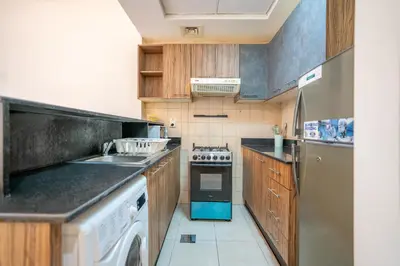 a kitchen with a sink and a stove top oven at RH- Studio Retreat, Walk away to Burj Khalifa and Dubai Mall in Dubai