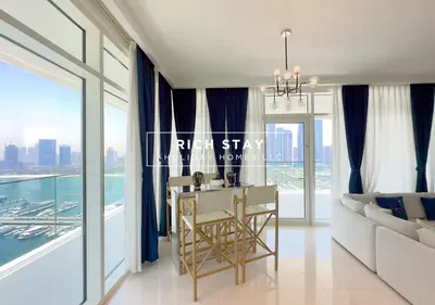 a living room with a table and a large window at Sunrise Bay 3BR EMAAR Beachfront Dubai Harbour by Rich Stay in Dubai