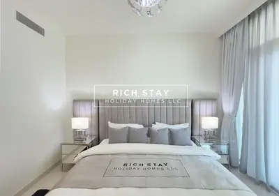 a bedroom with a large bed and two lamps at Sunrise Bay 3BR EMAAR Beachfront Dubai Harbour by Rich Stay in Dubai
