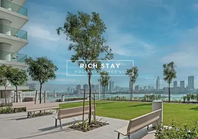 a view of a park with benches and a tree at Sunrise Bay 3BR EMAAR Beachfront Dubai Harbour by Rich Stay in Dubai