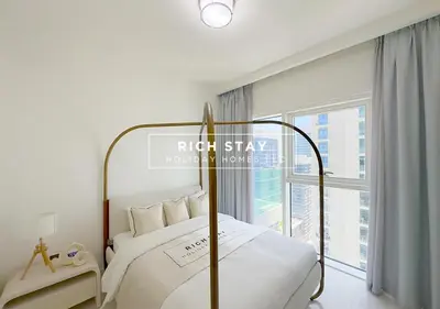 a bedroom with a bed and a large window at Sunrise Bay 3BR EMAAR Beachfront Dubai Harbour by Rich Stay in Dubai