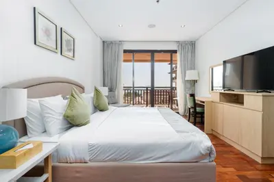 a hotel room with a bed and a television at Lux BnB I Palm Jumeirah Resort I Palm Views in Dubai