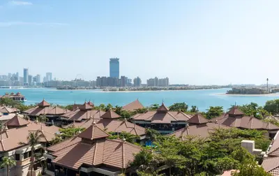 a view of the city and the water with houses at Lux BnB I Palm Jumeirah Resort I Palm Views in Dubai