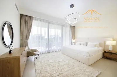 a bedroom with a white bed and a mirror at NewArabian Dubai Hills Sidra Villa in Dubai