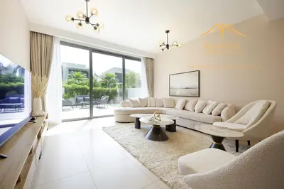 a living room with a couch and a table at NewArabian Dubai Hills Sidra Villa in Dubai
