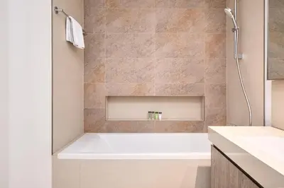 a bathroom with a bath tub and a sink at BellaVista Downtown Views II Tower 1 Modern 2BR Downtown City View in Dubai