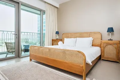 a bedroom with a bed and a balcony at BellaVista Downtown Views II Tower 1 Modern 2BR Downtown City View in Dubai