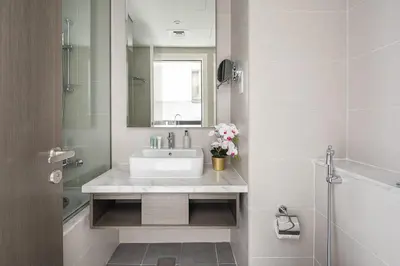 a white bathroom with a sink and a mirror at Frank Porter - Prive A in Dubai