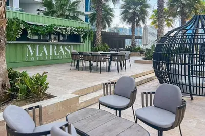 a group of chairs and tables in a patio at Frank Porter - Prive A in Dubai