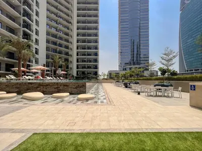 a courtyard with tables and chairs and buildings at GuestReady - A sophisticated and refined dwelling in Dubai
