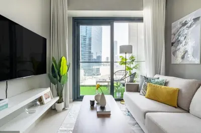 a living room with a white couch and a large window at GuestReady - A sophisticated and refined dwelling in Dubai