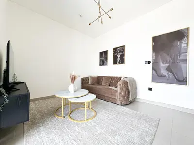 a living room with a couch and a table at Trophy - Maison de Charme Suite in Dubai