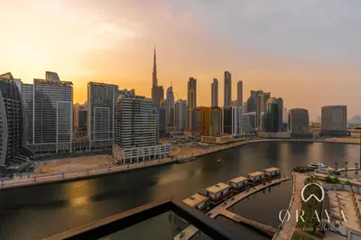 a view of a city with a river and buildings at Oraya - Studio With Jaw-Dropping Canal and Burj Views - Business bay in Dubai