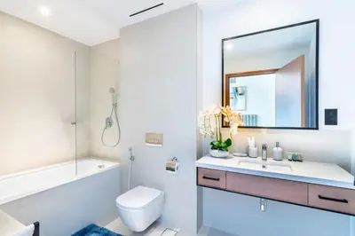 a bathroom with a sink and a toilet and a mirror at Welcome Home Apartments - VIDA Marina - Full Marina view - High Floor in Dubai