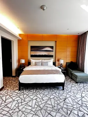 a bedroom with a large bed and a couch at Fashion Avenue Dubai Mall Burj Khalifa View Residence- Formerly Address Dubai Mall in Dubai
