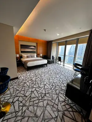 a large bedroom with a bed and a large window at Fashion Avenue Dubai Mall Burj Khalifa View Residence- Formerly Address Dubai Mall in Dubai