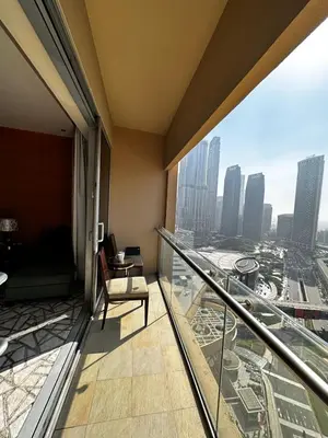 a room with a balcony with a view of a city at Fashion Avenue Dubai Mall Burj Khalifa View Residence- Formerly Address Dubai Mall in Dubai