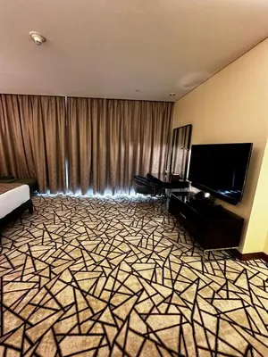 a hotel room with a bed and a flat screen tv at Fashion Avenue Dubai Mall Burj Khalifa View Residence- Formerly Address Dubai Mall in Dubai