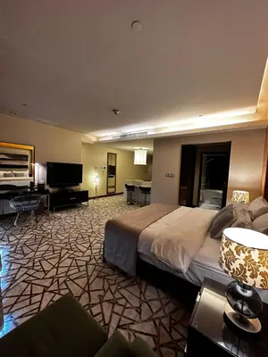 a hotel room with a bed and a flat screen tv at Fashion Avenue Dubai Mall Burj Khalifa View Residence- Formerly Address Dubai Mall in Dubai