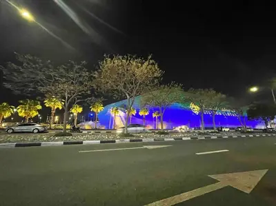 a building that is lit up blue at night at Studio in Silicon Oasis in Dubai