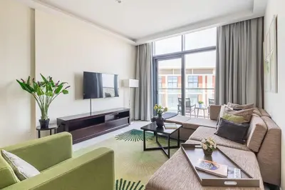 a living room with a couch and a tv at Frank Porter - Damac Celestia in Dubai