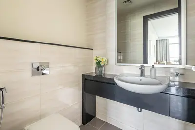 a bathroom with a sink and a mirror at Frank Porter - Damac Celestia in Dubai