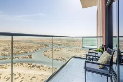 a balcony with two chairs and a view of the beach at Frank Porter - Damac Celestia in Dubai