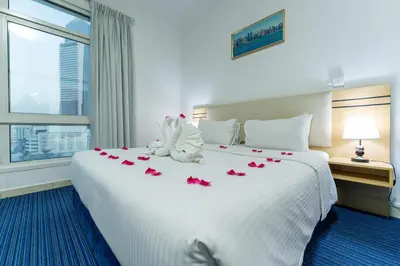 a hotel room with a bed with roses on it at Havana Holiday Homes Oud Metha in Dubai