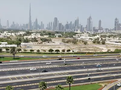 a highway with a city in the background at Havana Holiday Homes Oud Metha in Dubai