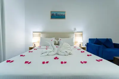 a bedroom with a bed with two towels at Havana Holiday Homes Oud Metha in Dubai