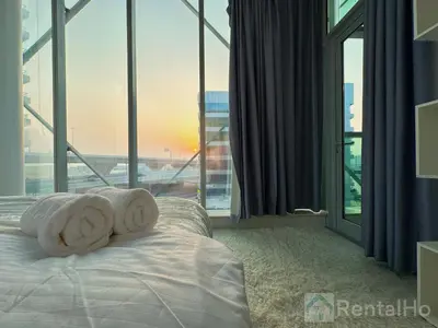 a bedroom with a bed with two towels on it at Lxry Full Marina View & RoofTop Pool 40% OFF in Dubai