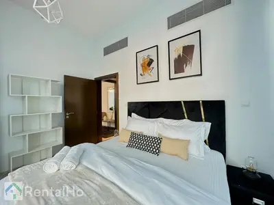 a bedroom with a large bed with white sheets and pillows at Lxry Full Marina View & RoofTop Pool 40% OFF in Dubai