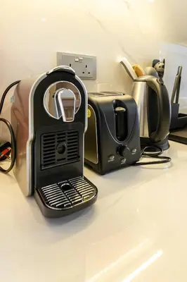 a toaster sitting on top of a counter at Modern Stu Near Downtown Dubai Pool Gym WiFi in Dubai