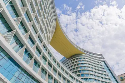 a tall building with a blue sky in the background at Studio with private beach access at Palm Jumeirah in Dubai