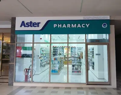 a pharmacy store with glass doors in a mall at White Sage - Designer Studio with Canal View & Largest Balcony in Dubai