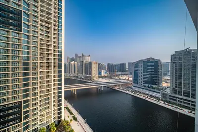 a view of a river in a city with buildings at White Sage - Designer Studio with Canal View & Largest Balcony in Dubai